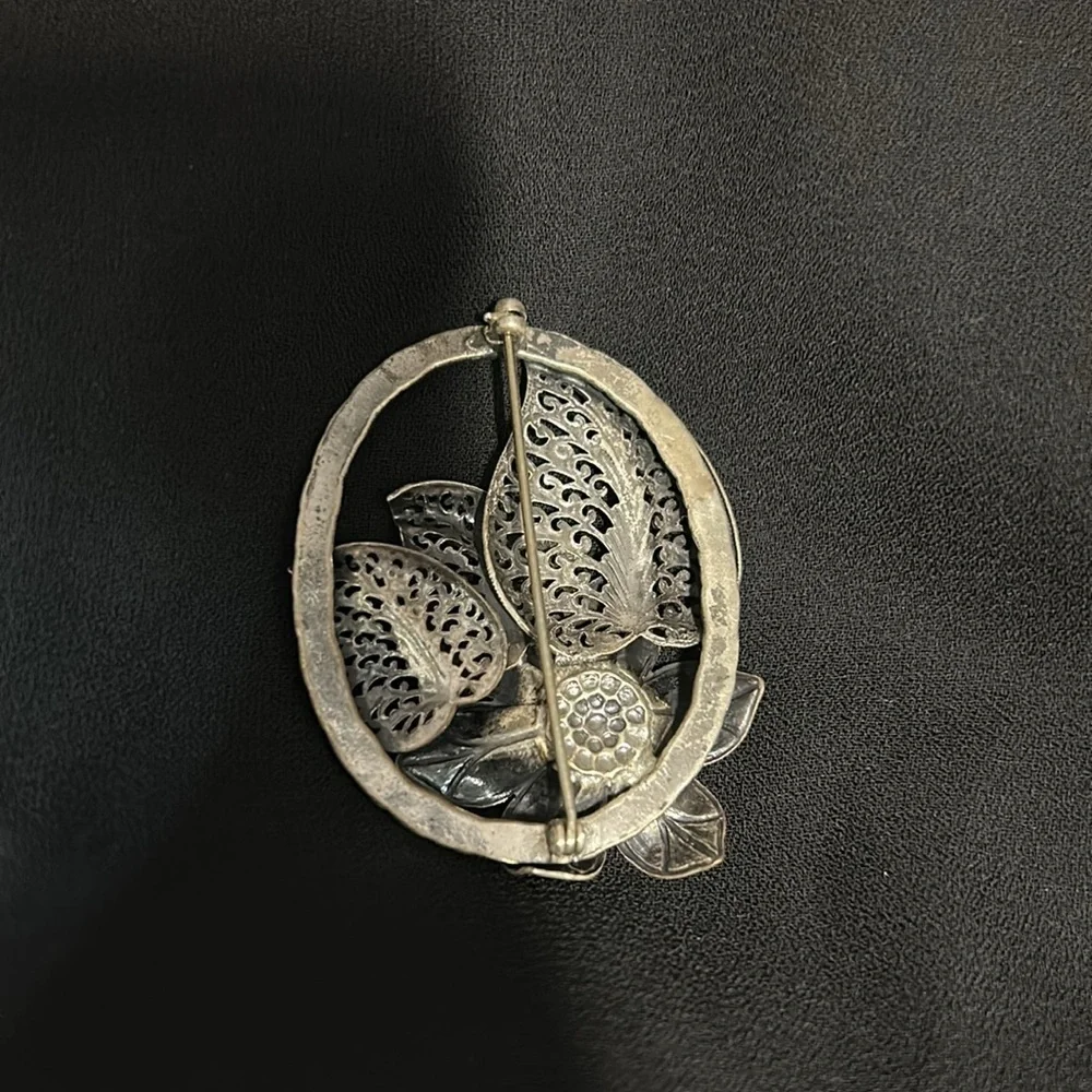 Elegant Silver Floral Brooch with Red Accent